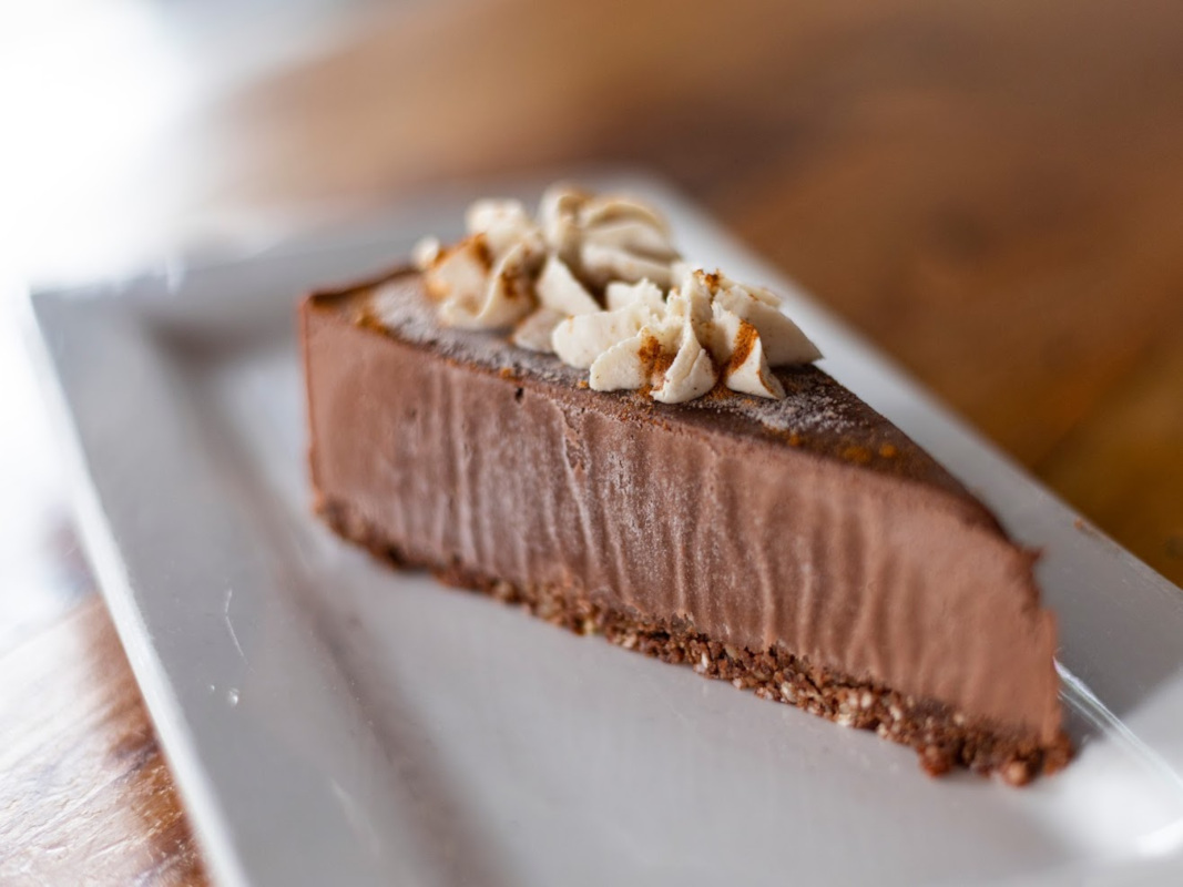 Chocolate cake slice with cream puffs